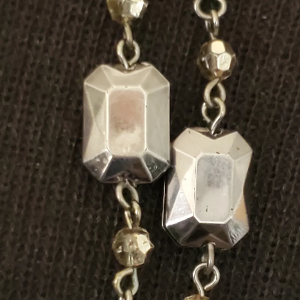 Silvertone and black bead and geometric stations necklace
